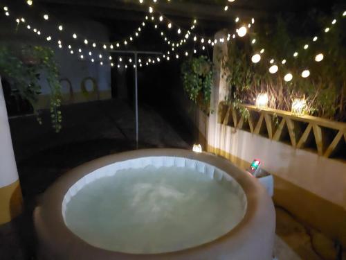 a bath tub in a room with lights at Montinho do Palanque in Viana do Alentejo