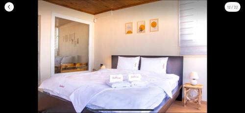 Un dormitorio con una gran cama blanca con dos almohadas. en Sound, en Konak