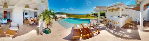 a house with a swimming pool and a patio at SUNSEEKER SXM - Luxury Guest House 4 stars - Amazing Sea View Pinel - Tintamarre in Orient Bay