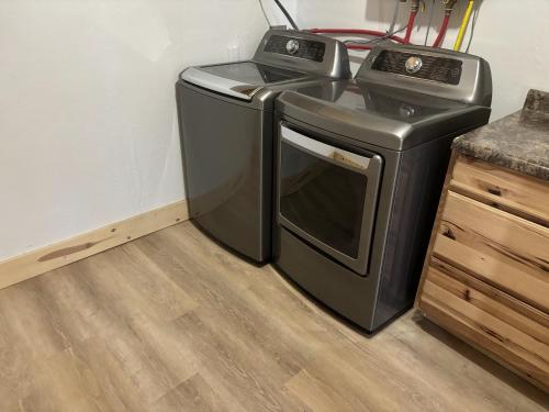 a washer and dryer sitting next to a counter at Chinook Winds Lodge in Dubois