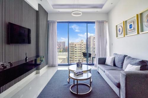 a living room with a couch and a table at Monaco Residences Piantini in Santo Domingo
