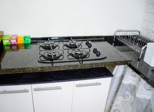 a stove top in a kitchen with a counter at Suítes Mathias flat 104 in Conservatória
