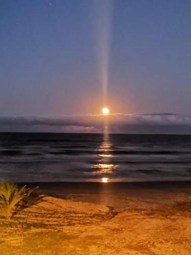a sunset over the ocean with a rainbow in the sky at Villa Playa Encantada in Barra de Tuxpan