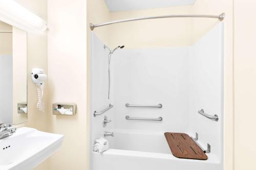 a bathroom with a shower with a wooden board in it at Best Western Nebraska City Inn in Nebraska City