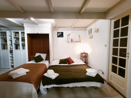 a bedroom with two beds with towels on them at Clos de Bigorre in Tabanac