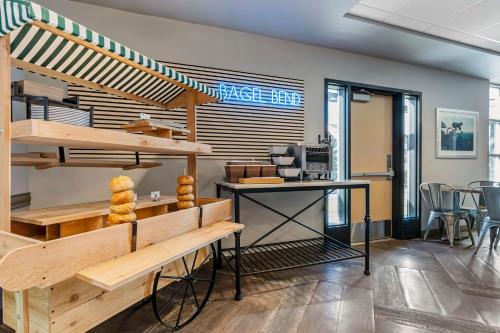 a bakery with a bench and a table in a room at Hotel Peppertree Bend, BW Premier Collection in Bend