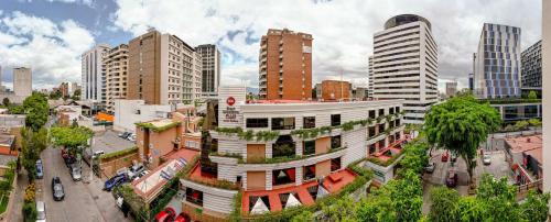 a city with tall buildings and a white building at Best Western Plus Hotel Stofella in Guatemala