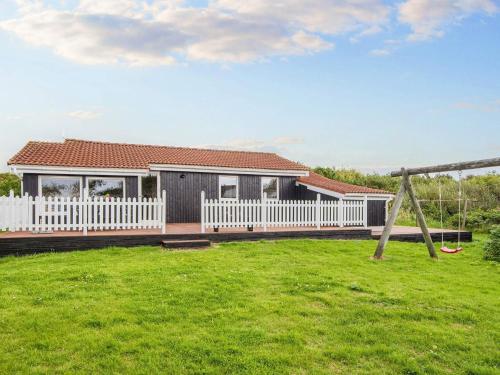a house with a white fence at 6 person holiday home in Ringkøbing-By Traum in Søndervig