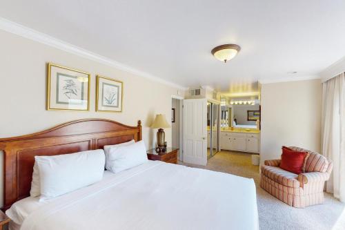 a bedroom with a large white bed and a chair at Silverado Resort and Spa 271 & 272 in Napa