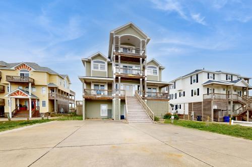 a row of houses with a driveway in front at Ocean Rush #2-HH in Hatteras