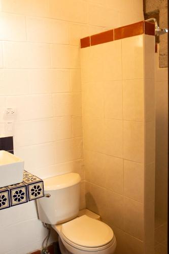 a bathroom with a white toilet and a sink at Cabañas Bungalos las Alazanas in San Antonio de las Alzanas
