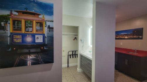 a bathroom with a trolley car painting on the wall at Presidio Parkway Inn in San Francisco