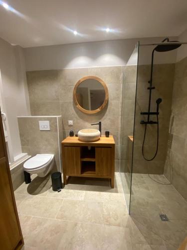 a bathroom with a toilet and a sink and a shower at Mio Plage in Sainte-Anne
