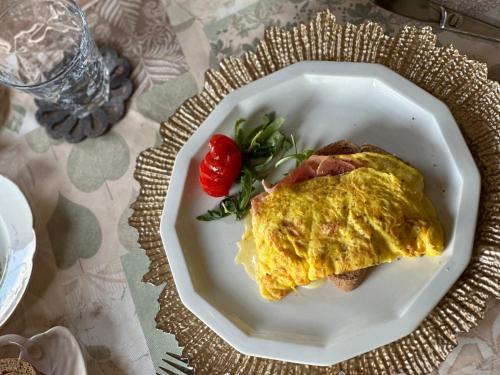 a white plate with an omelet on a table at B&B L'Orologio in Signa