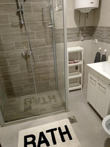a bathroom with a shower with a bathmat on the floor at MK Zlatibor in Zlatibor