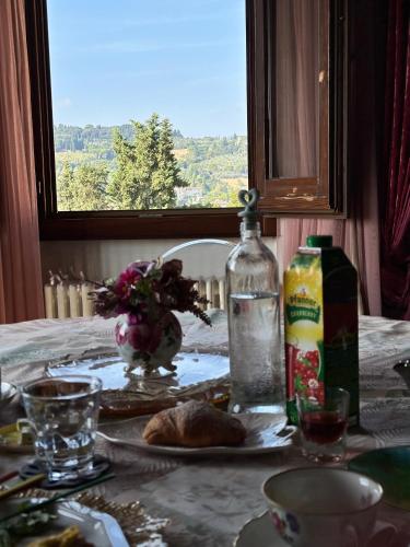 a table with a plate of food and a bottle of water at B&B L'Orologio in Signa