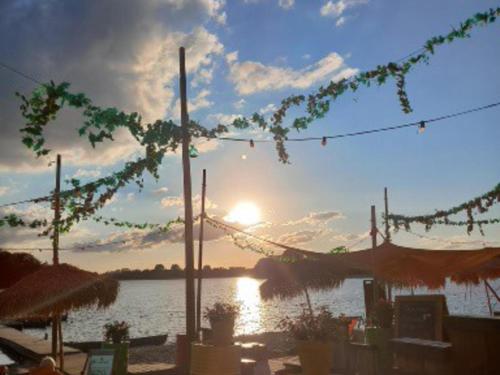 a sunset over a body of water with the sun at de Spil in Winterswijk-Meddo