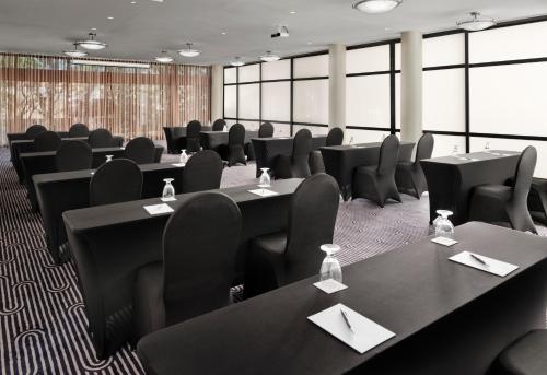 a conference room with black tables and chairs at Sheraton Ontario Airport Hotel in Ontario