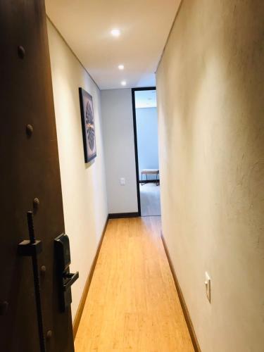 a hallway with a door leading to a room at Morph Candelaria - Gestion Hotelera in Bogotá