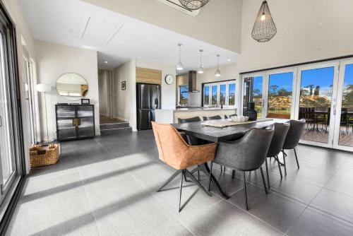 a kitchen and dining room with a table and chairs at Limestone Views in Swan Reach