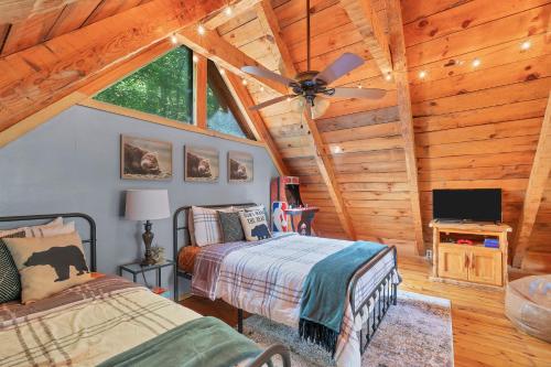 a bedroom with a bed and a ceiling fan at Whispering Pines in Townsend