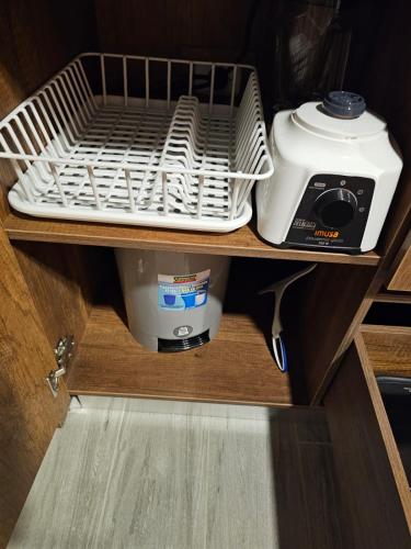 a kitchen appliance sitting on a shelf in a drawer at Apto en Pereira 2 Dobles Hermoso Moderno in Pereira