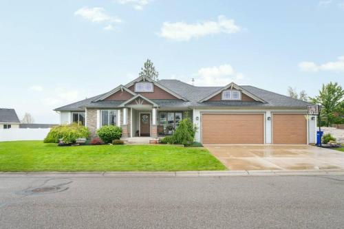 a house with a garage on a street at Spacious Rustic House in Spokane Valley