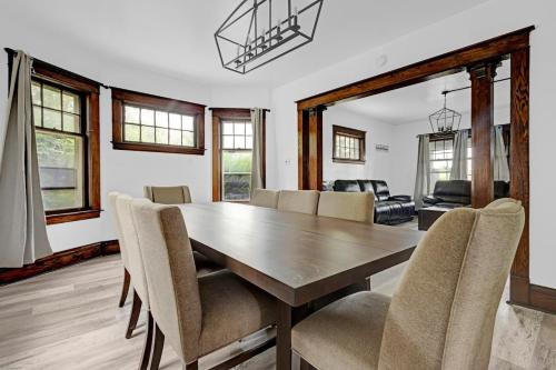 a dining room with a wooden table and chairs at Spacious 4BR 1BA near the Falls in Niagara Falls
