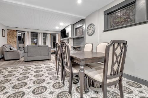 a dining room with a table and chairs at Renovated 6BR 2BA Minutes from Falls and Casino in Niagara Falls