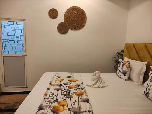 a bedroom with a bed with yellow birds on it at Galle Wonvil Apartment in Galle