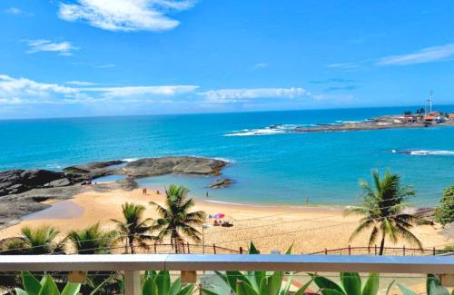 a view of a beach with palm trees and the ocean at Hotel Atlântico in Guarapari