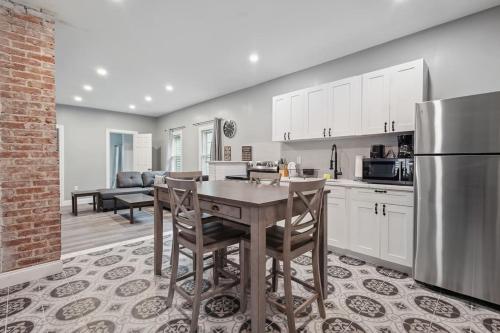 a kitchen with a table and a refrigerator at Cozy 3BR 2BA minutes from the Falls in Niagara Falls
