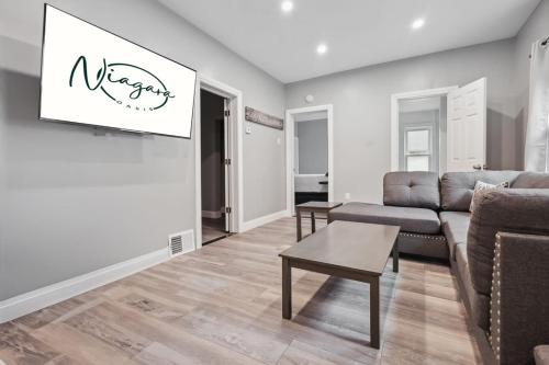 a living room with a couch and a table at Cozy 3BR 2BA minutes from the Falls in Niagara Falls