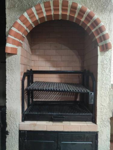 a brick oven with a bench in a brick wall at Casa Emaús in Calacala