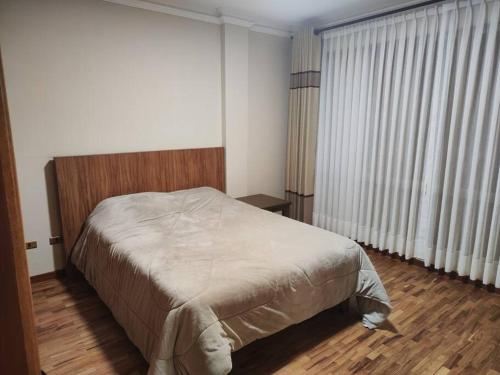 a bedroom with a bed and a large window at Casa Emaús in Calacala