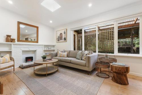 a living room with a couch and a fireplace at Discover Elegance at Silvermist in Kallista