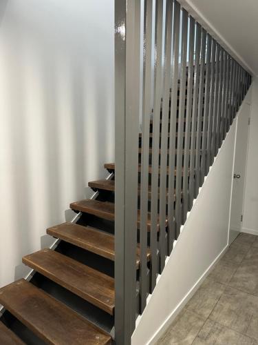 a staircase in a house with wooden steps at Stonewood Views in Diwan