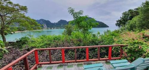 a deck with chairs and a view of the water at Phi Phi View Point Resort in Phi Phi Don