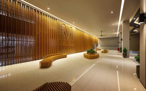 a lobby with couches and chairs in a building at M Centura Sentul KL Fully Air Con Blissful Suite KL in Kuala Lumpur