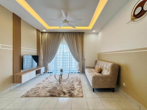 a living room with a couch and a tv at Youth City Residence Nilai in Nilai