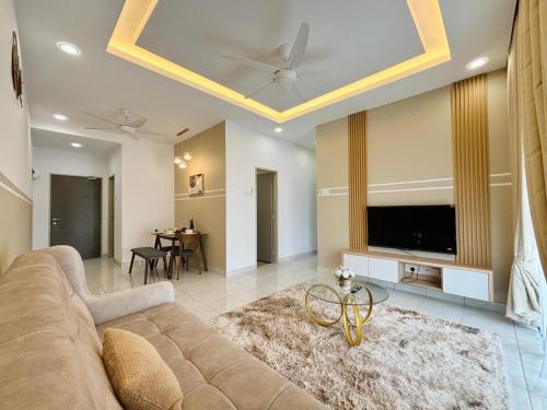 a living room with a couch and a flat screen tv at Youth City Residence Nilai in Nilai
