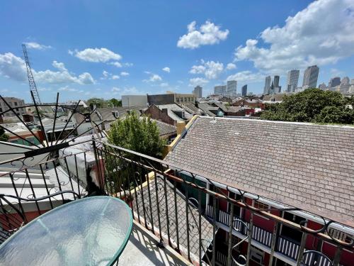 a table and chairs on a balcony with a view of the city at Hotel Villa Convento in New Orleans