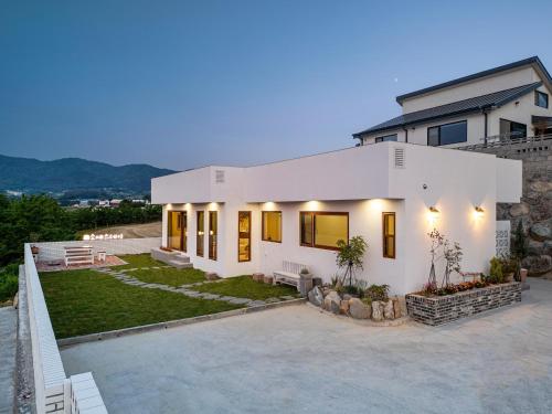 a large white house with a yard at Soye stay in Gyeongju