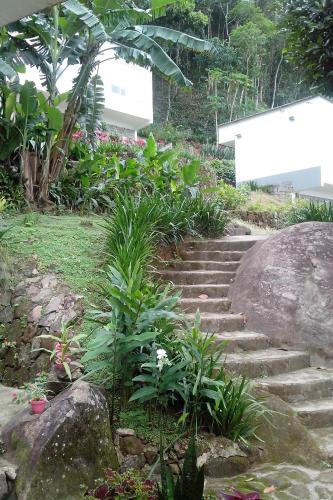a set of stairs in a garden with plants at Pousada Piquara in Mangaratiba