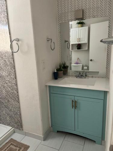 a bathroom with a blue cabinet and a sink at Peaceful Vegas in Las Vegas