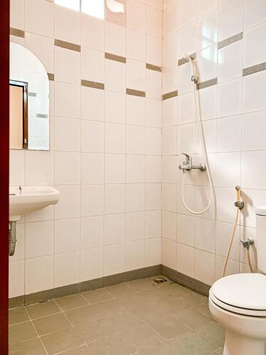 a bathroom with a toilet and a sink at Kamulyan Heritage Family in Yogyakarta
