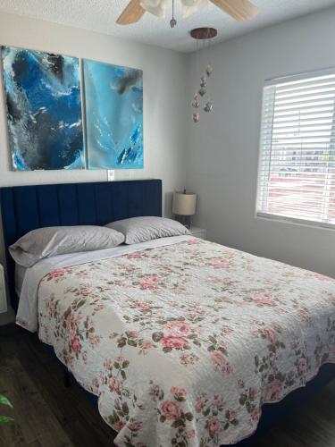 a bedroom with a bed and two paintings on the wall at Peaceful Vegas in Las Vegas