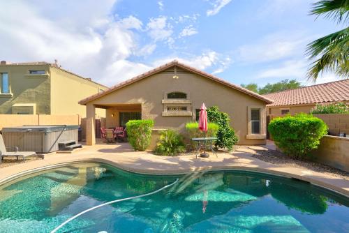 a swimming pool in front of a house at San Tan Valley Vacation Home in Johnson Ranch! in San Tan Valley