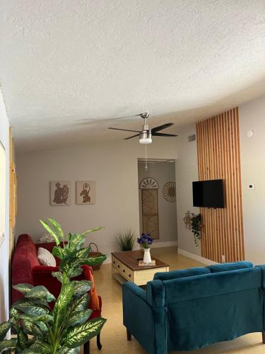 a living room with a blue couch and a ceiling fan at Peaceful Vegas in Las Vegas