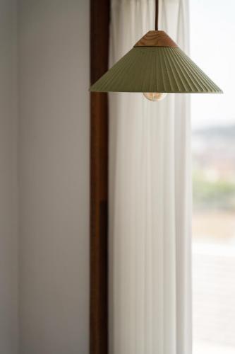 a lamp hanging from a window in a room at Soye stay in Gyeongju